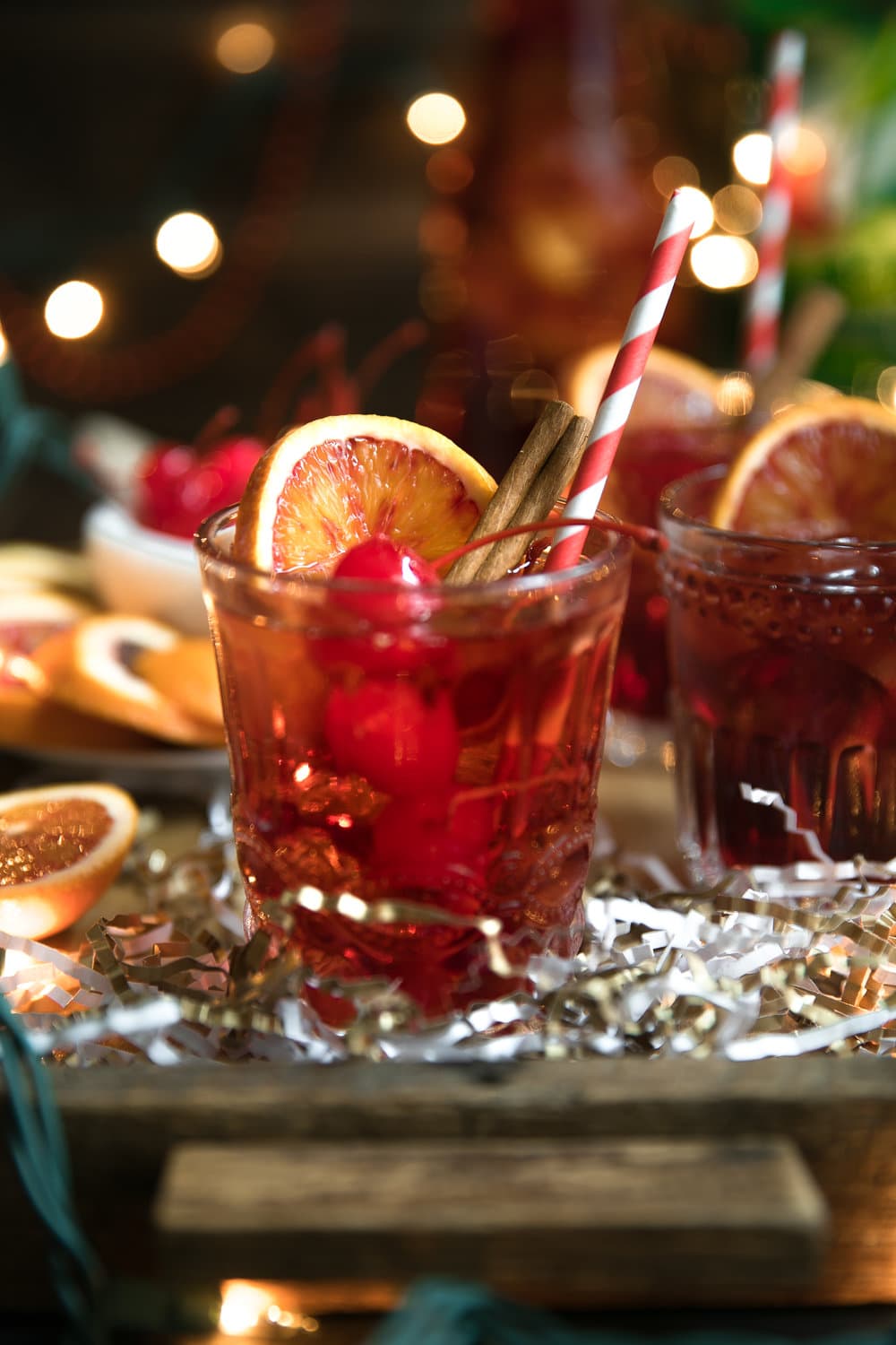 Cinnamon liqueur, bourbon, tart cherry juice, fresh orange wedges and sweet bubbly 7UP mix together to make this Orange and Cherry 7UP Spritzer; a delicious holiday cocktail