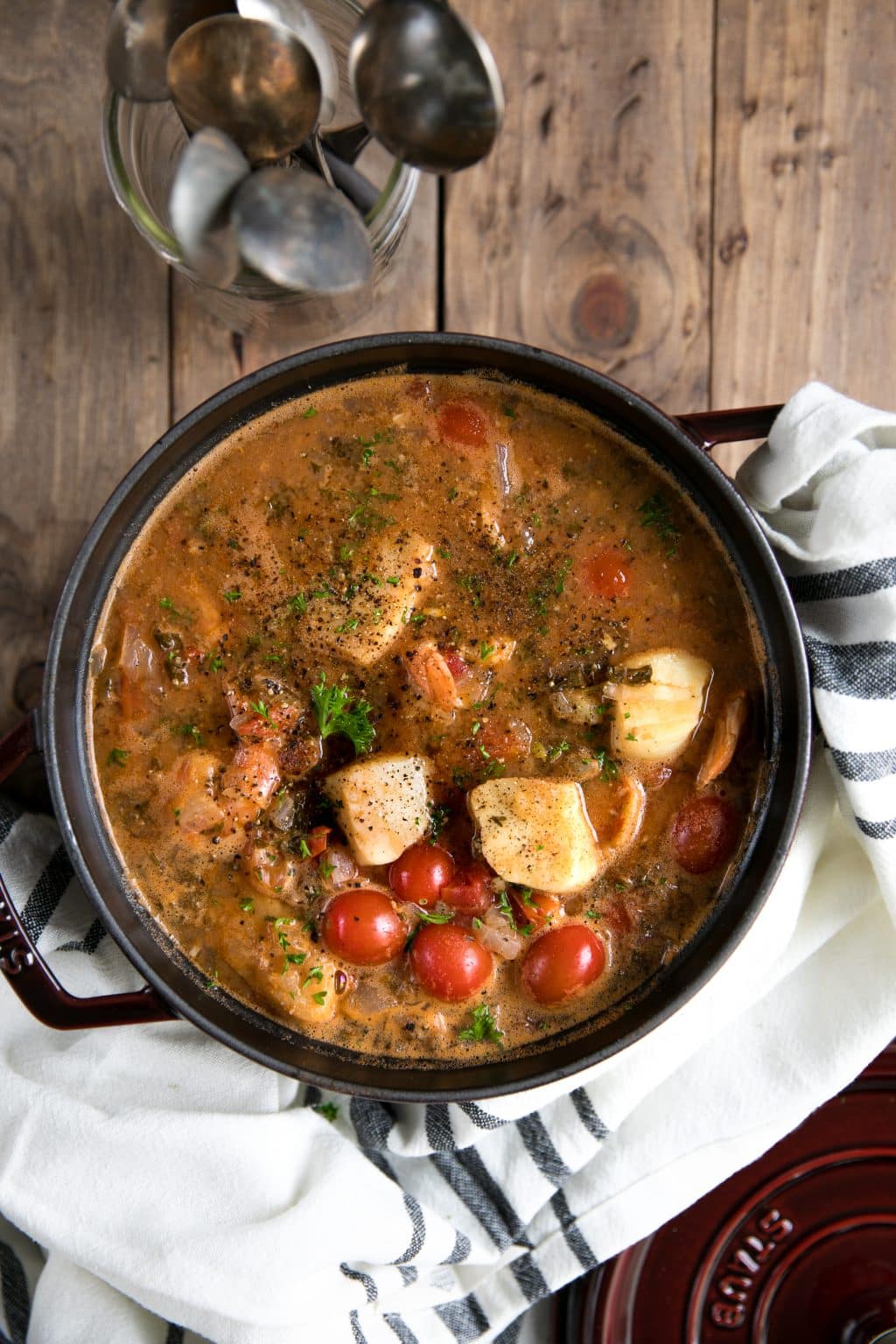 Pot of fish soup with fresh chunks of white fish, juicy shrimp, and a rich, comforting tomato broth.