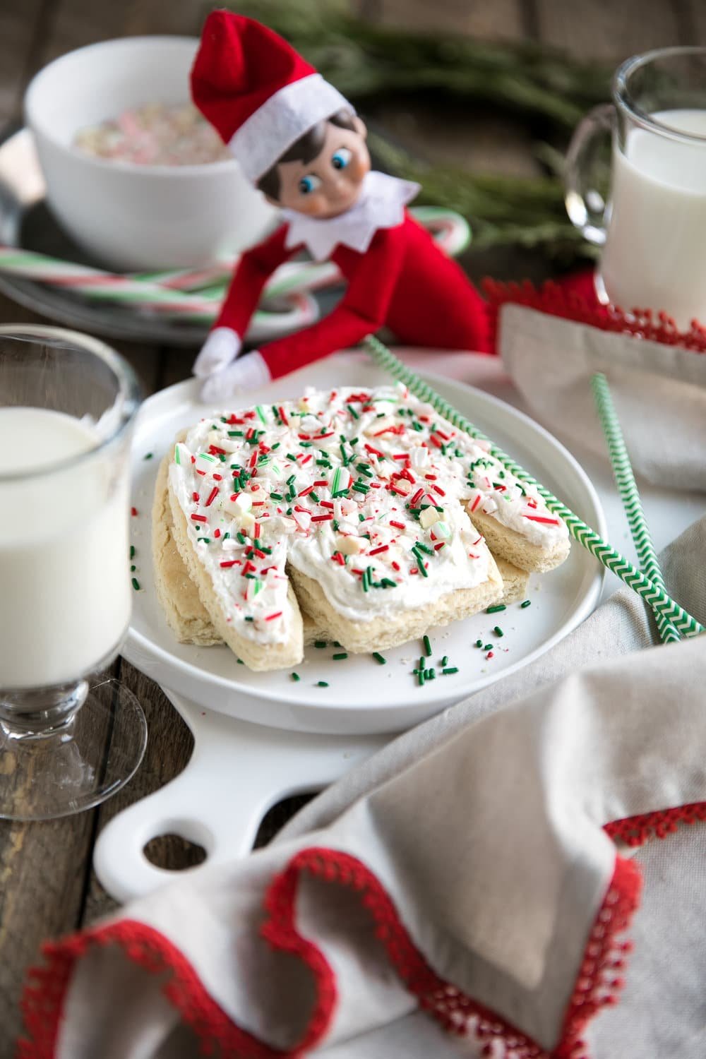 A cup ugly sweater sugar cookie with elf