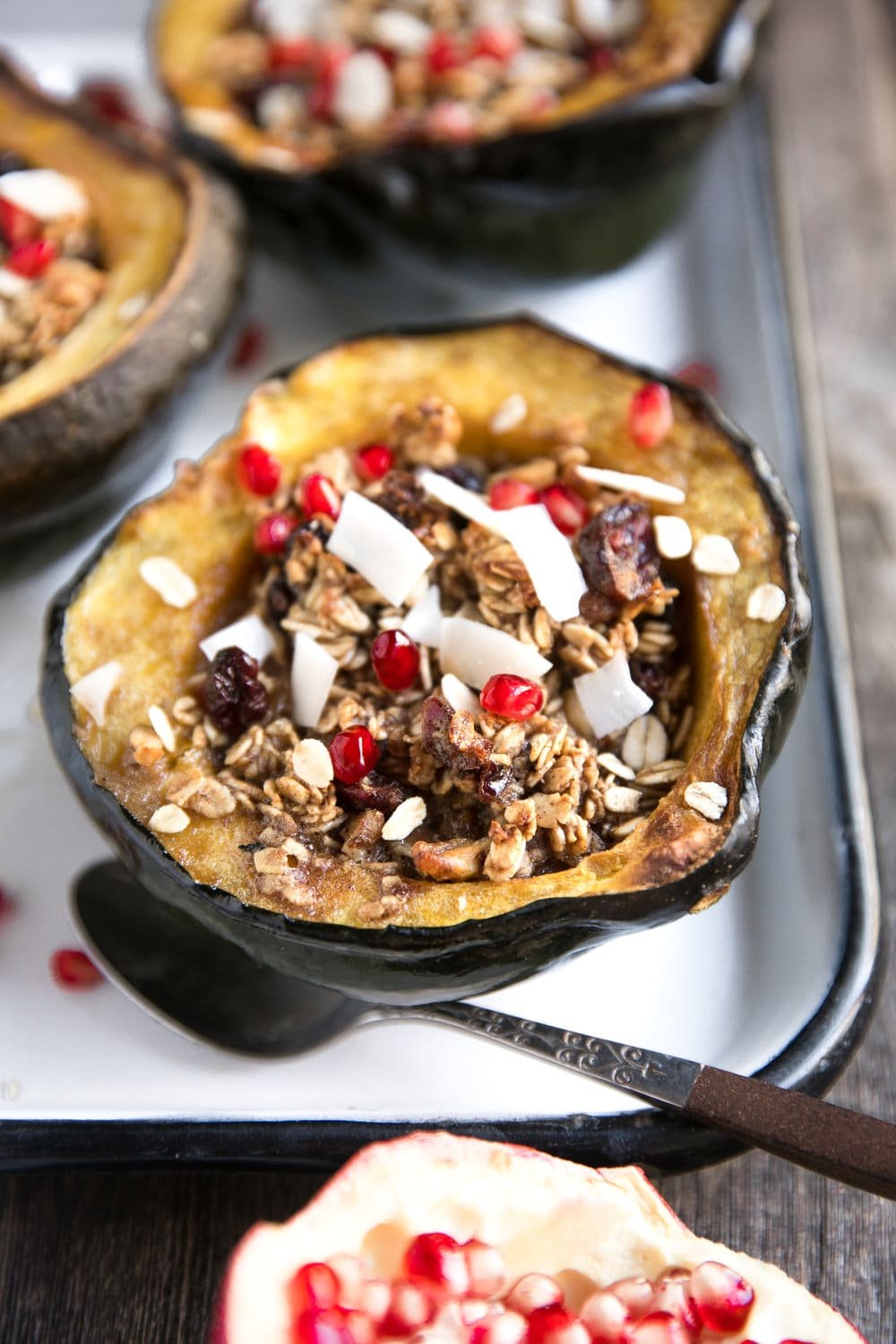 Sweet Cinnamon Baked Oatmeal Stuffed Acorn Squash with Almond Butter, Cranberries, and Pomegranates