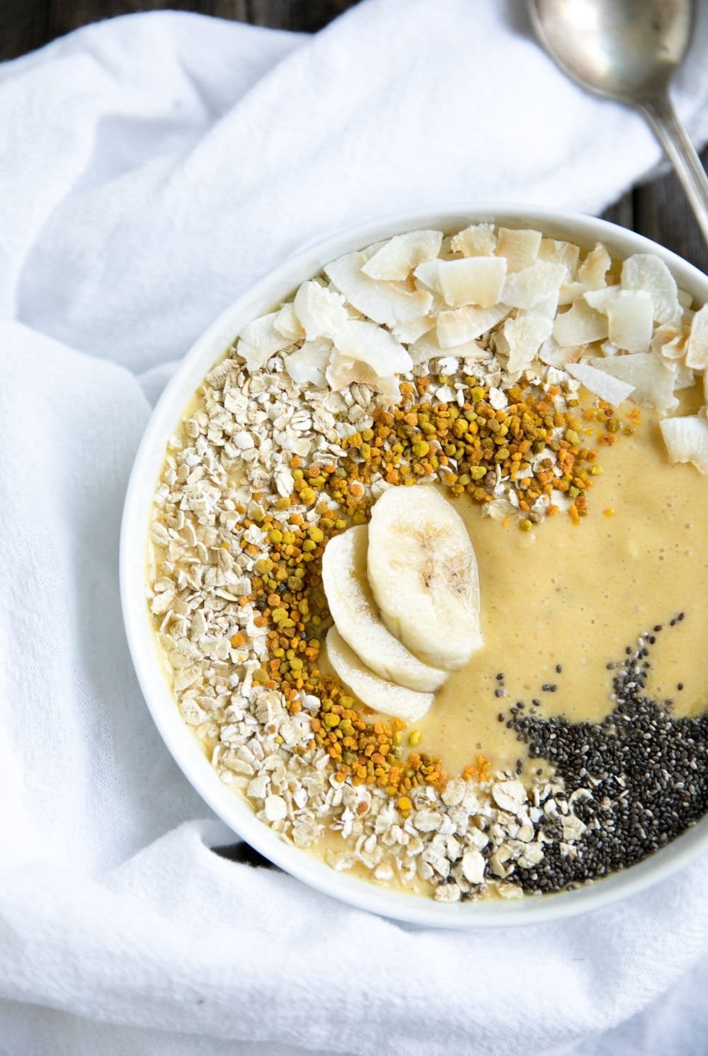 A dessert on a plate, with Banana Mango Smoothie Bowl
