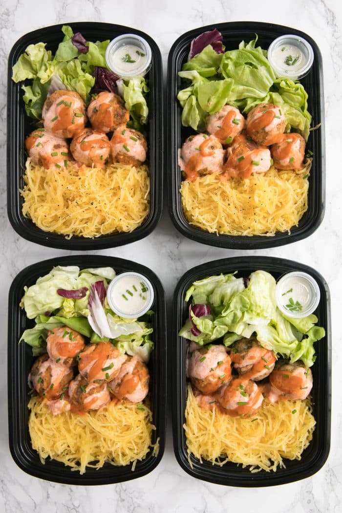 Buffalo Turkey Meatballs in meal prep containers with lettuce, spaghetti squash, and ranch dressing