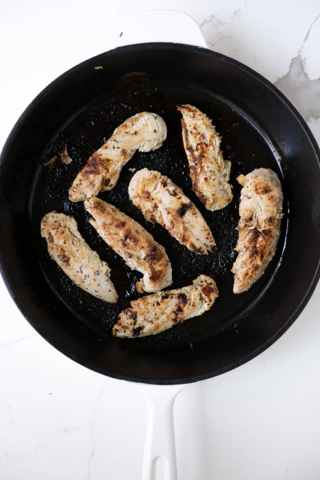 Fully cooked yogurt marinated chicken in a cast iron skillet