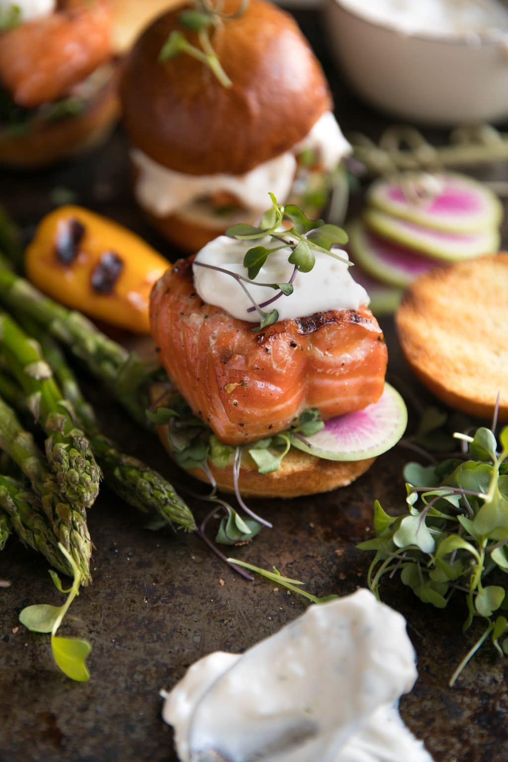 Grilled Salmon Sliders topped with Garlic Lemon Aioli on a mini brioche bun.