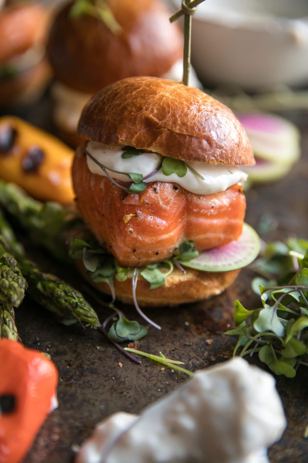 Grilled Salmon Slider topped with Garlic Lemon Aioli and microgreens on a toasted brioche bun