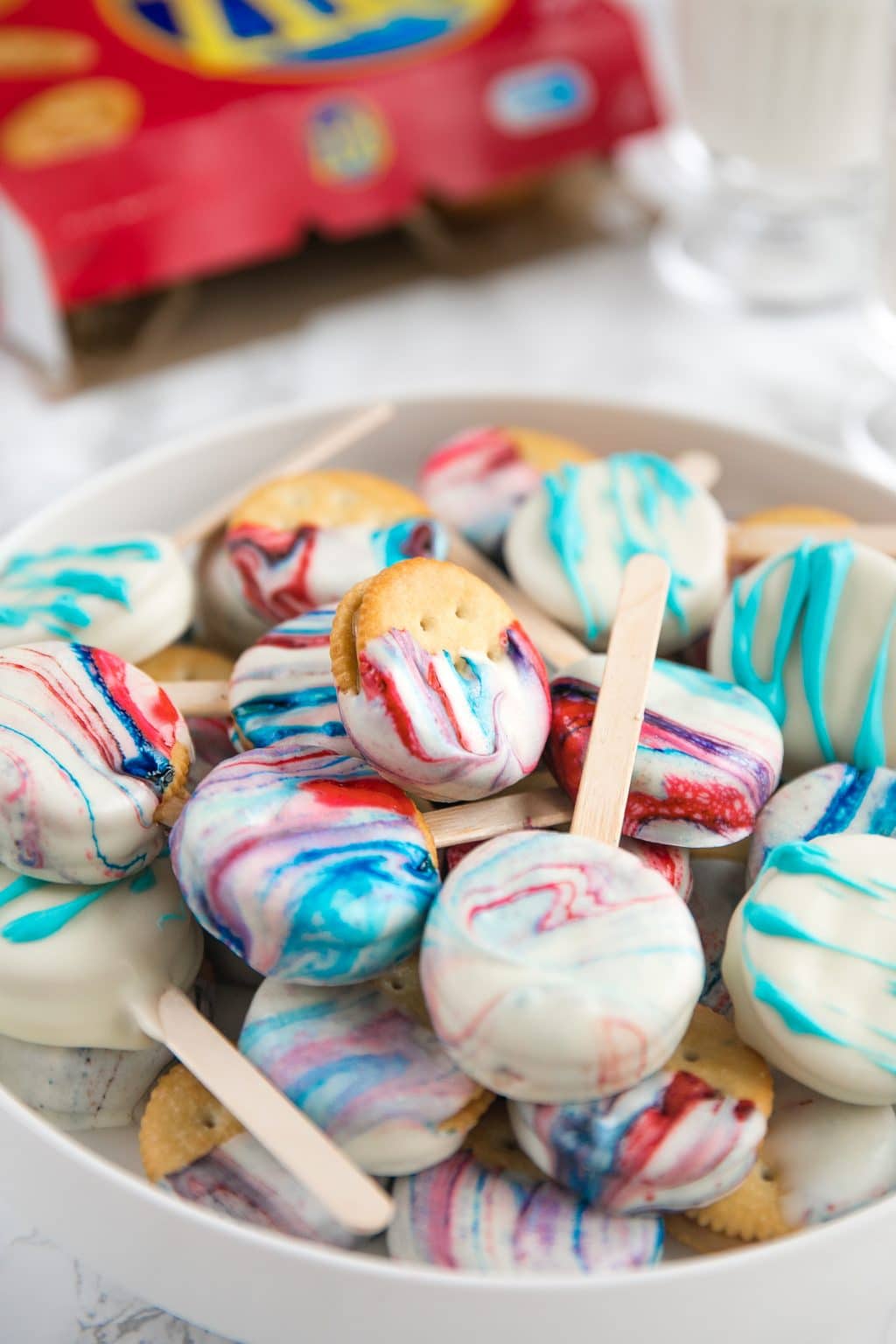 Creamy Peanut Butter Sandwiched between Buttery RITZ Cracker and dipped in swirled Red, White, and Blue melted white Chocolate