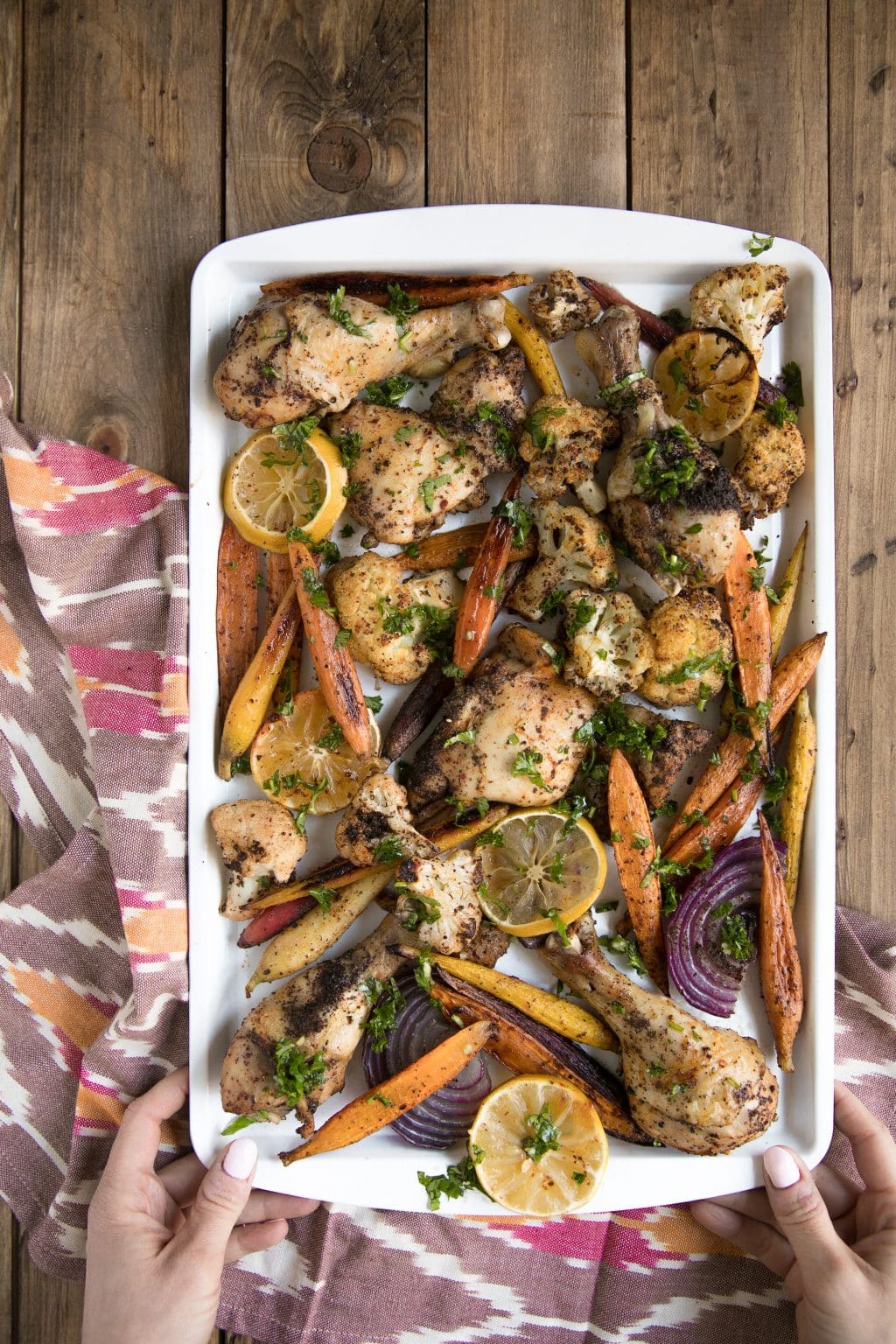 Sumac Chicken with Lemony Roasted Carrots, Cauliflower and Onion in white pan from above