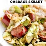 Close-up of a bowl filled with cabbage, kielbasa, and white beans, a hearty, dairy-free and gluten-free dinner option for quick family meals.