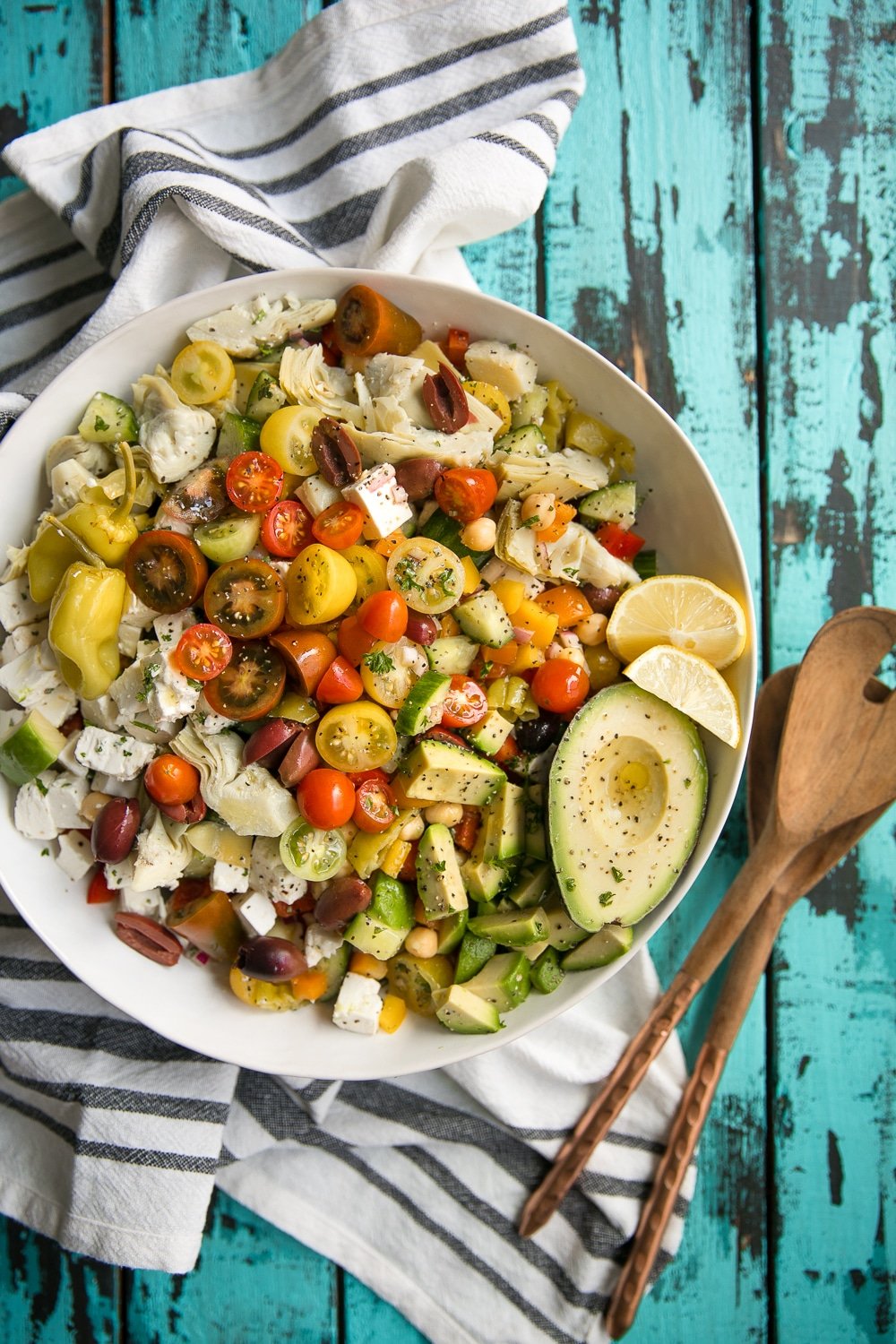 Easy Vegetarian Chopped Mediterranean Salad with chickpeas, avocado, tomatoes, bell pepper, olives, and artichoke hearts.