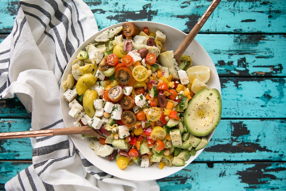 Easy Vegetarian Chopped Mediterranean Salad with chickpeas, avocado, tomatoes, bell pepper, olives, and artichoke hearts.