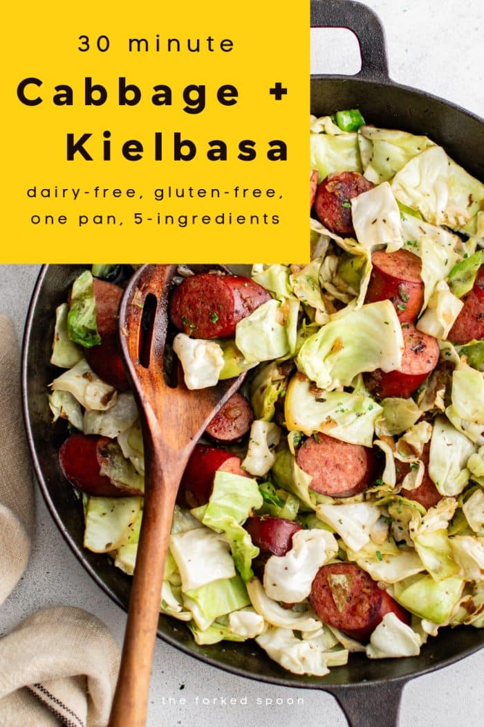 Overhead photo of a cast iron skillet filled with sizzling kielbasa sausage and sautéed cabbage, a quick and easy one-pan meal idea.