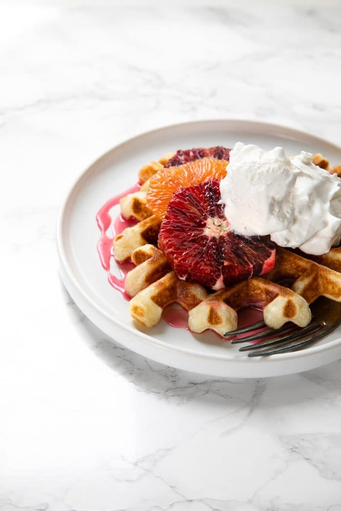 Light, fluffy and perfectly crisp around the edges, these Easy Crispy Waffles with Blood Orange Glaze are delicious for breakfast, brunch, dinner, or even dessert!