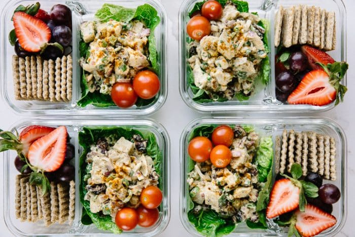 Prepared weekly chicken salad meal prep snack trays with fruit