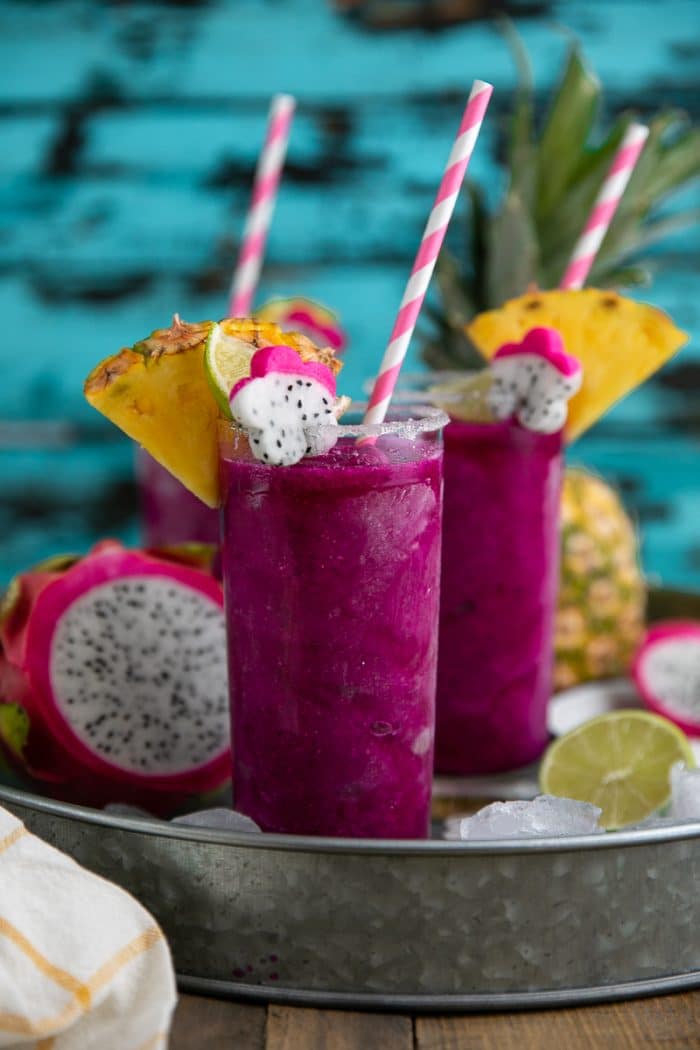 Frozen Dragon Fruit Margaritas on tray with straw