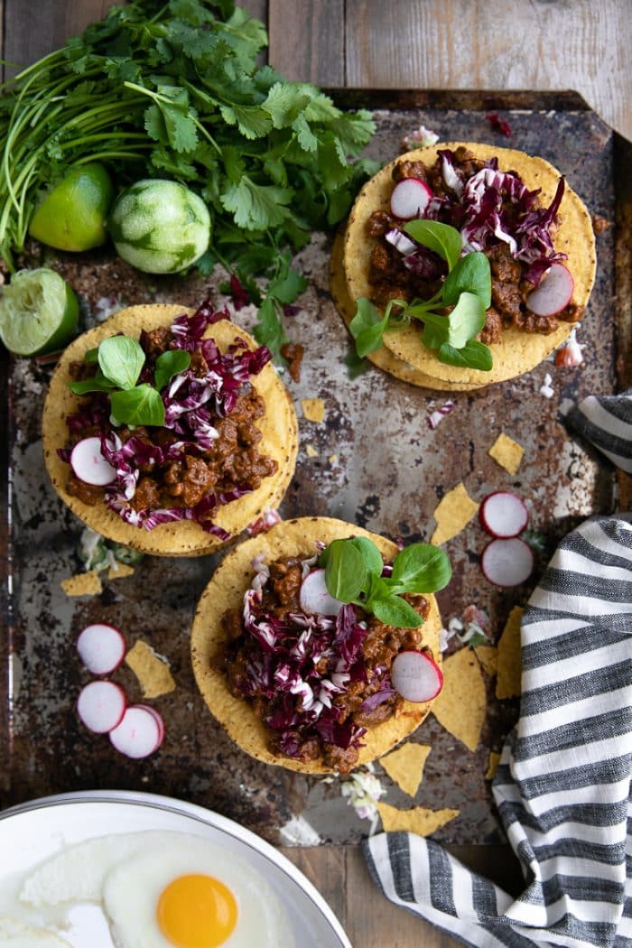 Ground turkey mole tostadas on a large baking sheet.