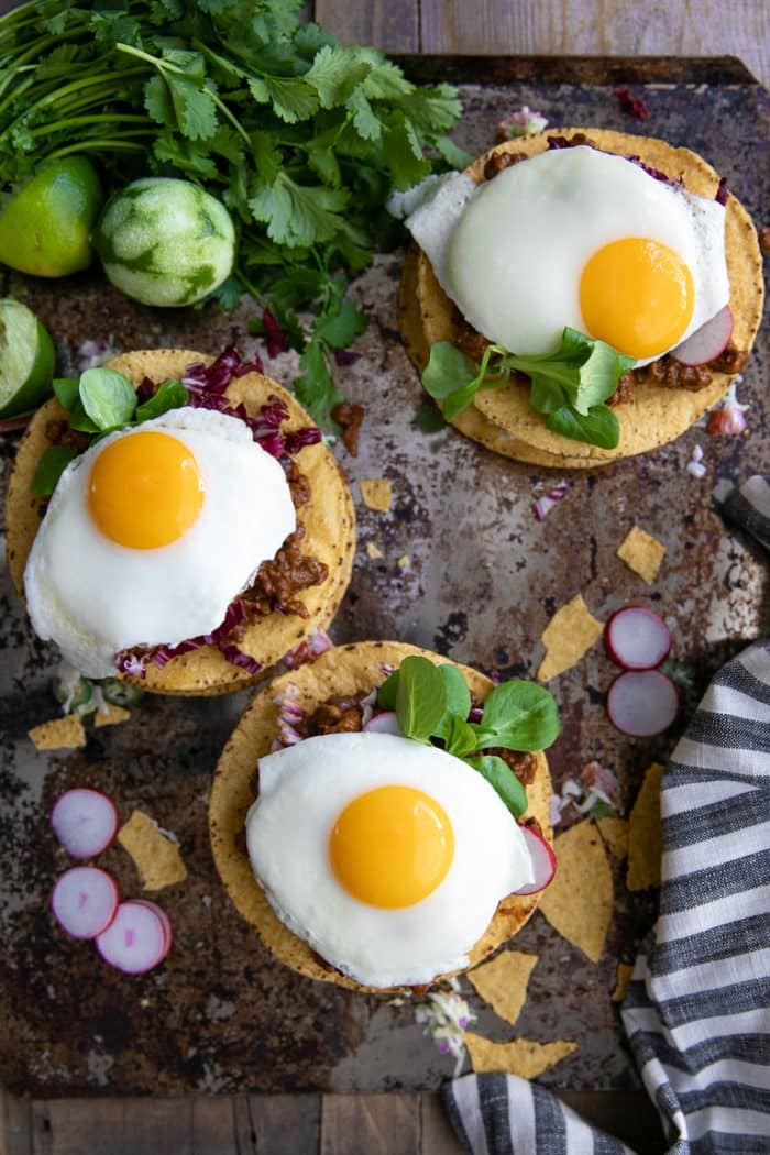 Fried eggs on top of stacked tostadas