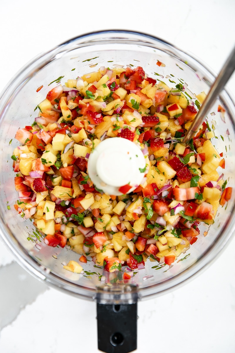 Fresh fruit salsa, quinoa, and roasted broccolini pair up with Omega-rich salmon in this crazy easy and super healthy Macadamia Crusted Salmon with Pineapple Mango Salsa.