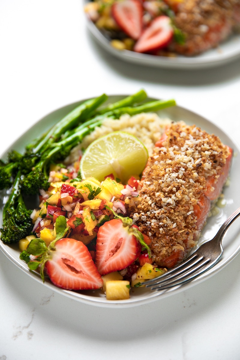 Fresh fruit salsa, quinoa, and roasted broccolini pair up with Omega-rich salmon in this crazy easy and super healthy Macadamia Crusted Salmon with Pineapple Mango Salsa.