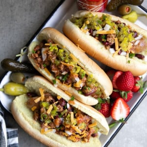 Easy Instant Pot Coca-Cola Chili and Sausage Dogs. Hearty beef chili cooked in the Instant Pot under 30 minutes. Serve at your next bbq alongside a full sausage dog bar!