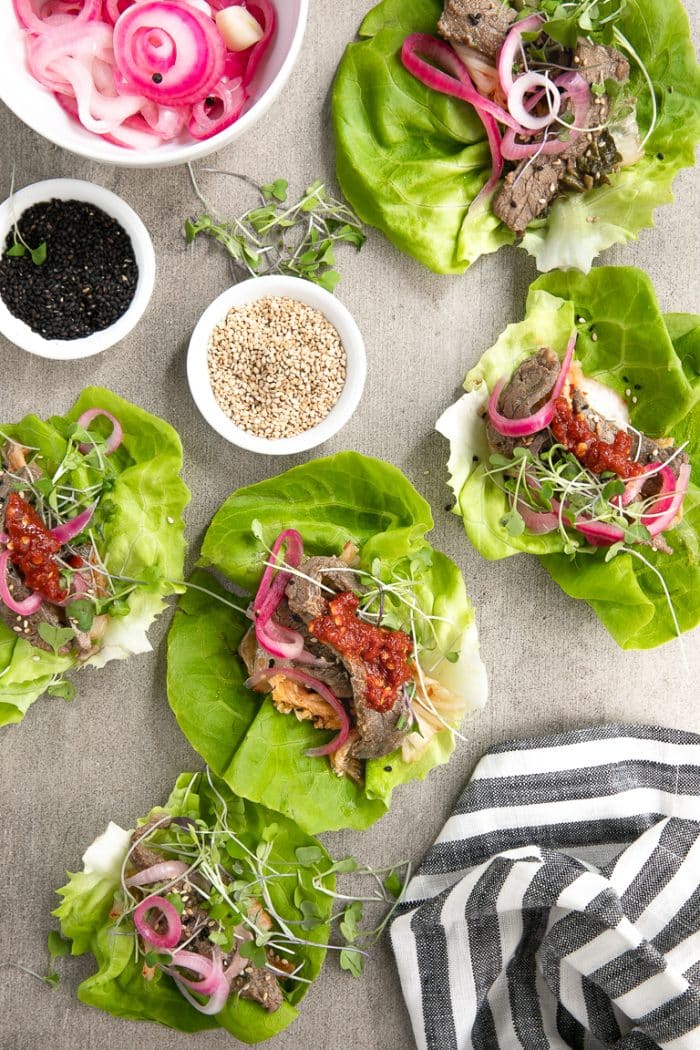 Korean BBQ Beef served with kimchi, pickled red onions, butter lettuce and micro greens