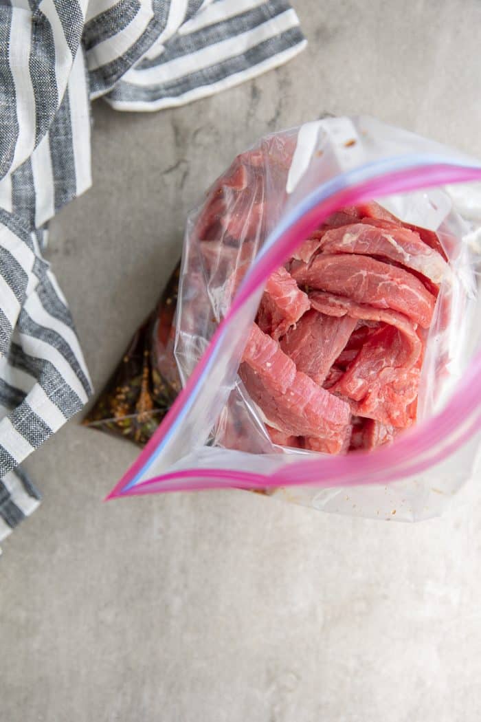 Thinly sliced sirloin beef in a plastic bag marinating in homemade bulgogi marinade.