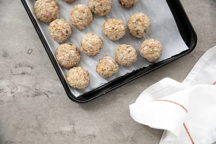 Fully cooked meatballs on tray ready to place in the freezer