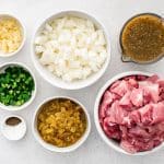 All ingredients for Crock Pot Chili Verde recipe are presented in individual measuring cups and ramekins.