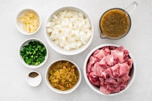 All ingredients for Crock Pot Chili Verde recipe are presented in individual measuring cups and ramekins.