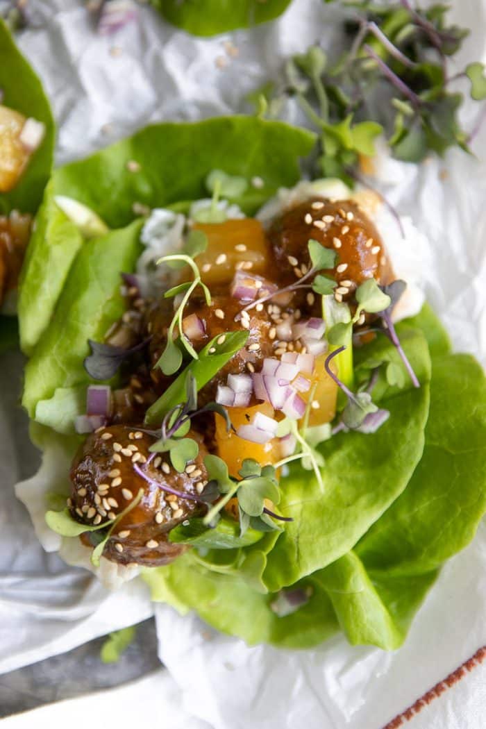 Fresh butter lettuce filled with hawaiian meatballs, pineapple chunks, microgreens, and chopped red onion.