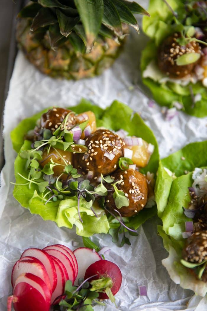 Fresh butter lettuce filled with hawaiian meatballs, pineapple chunks, microgreens, and chopped red onion.