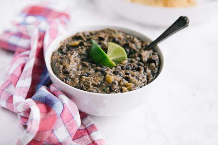 Large white bowl filled with homemade refried black beans.