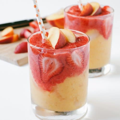 A close up of a glass of Smoothie with Strawberry and Mango