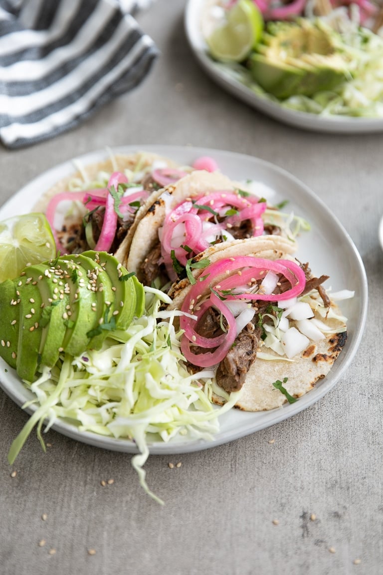 A plate of shredded beef tacos on a table
