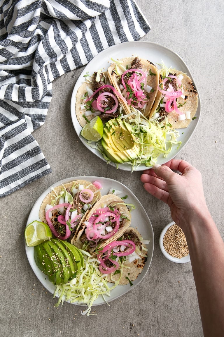 Two plates with Lime Teriyaki Shredded Beef Tacos
