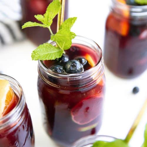 A close up of glasses filled with Blueberry Sangria