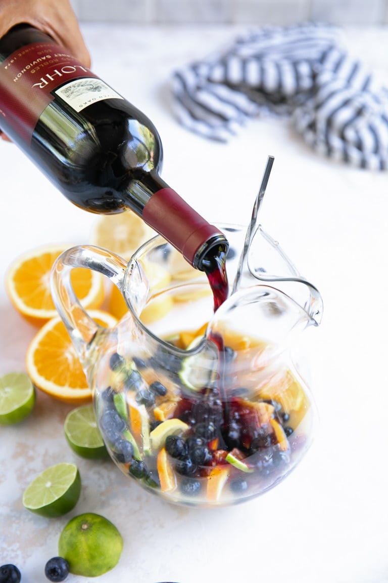 Pouring Cabernet Sauvignon into pitcher the Blueberry Sangria