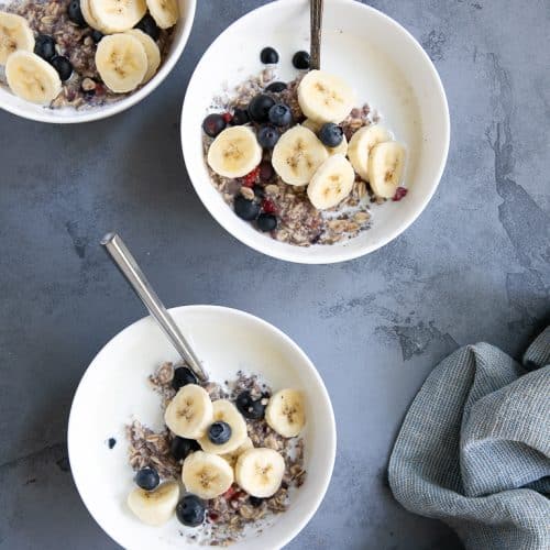 Bowls of instant oatmeal with berries and bananas