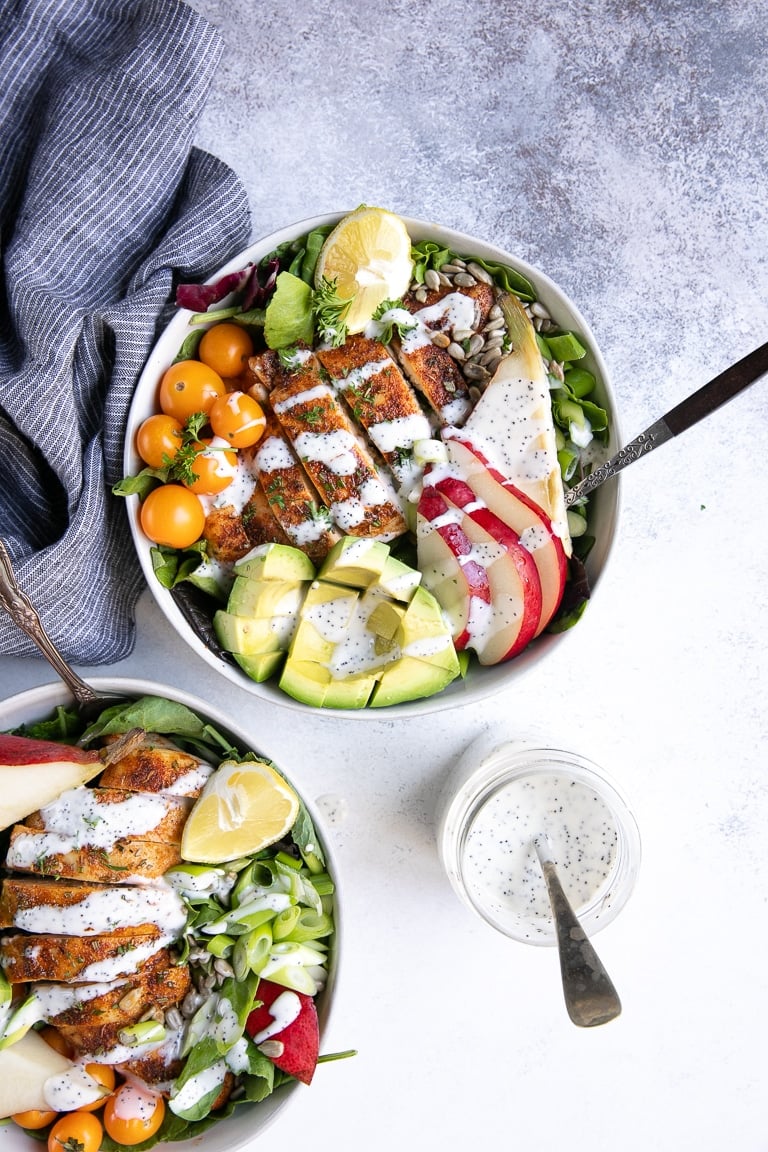 Overhead image of prepared and styled salad bowls filled with Autumn Chicken and Pear Salad with Poppyseed Dressing