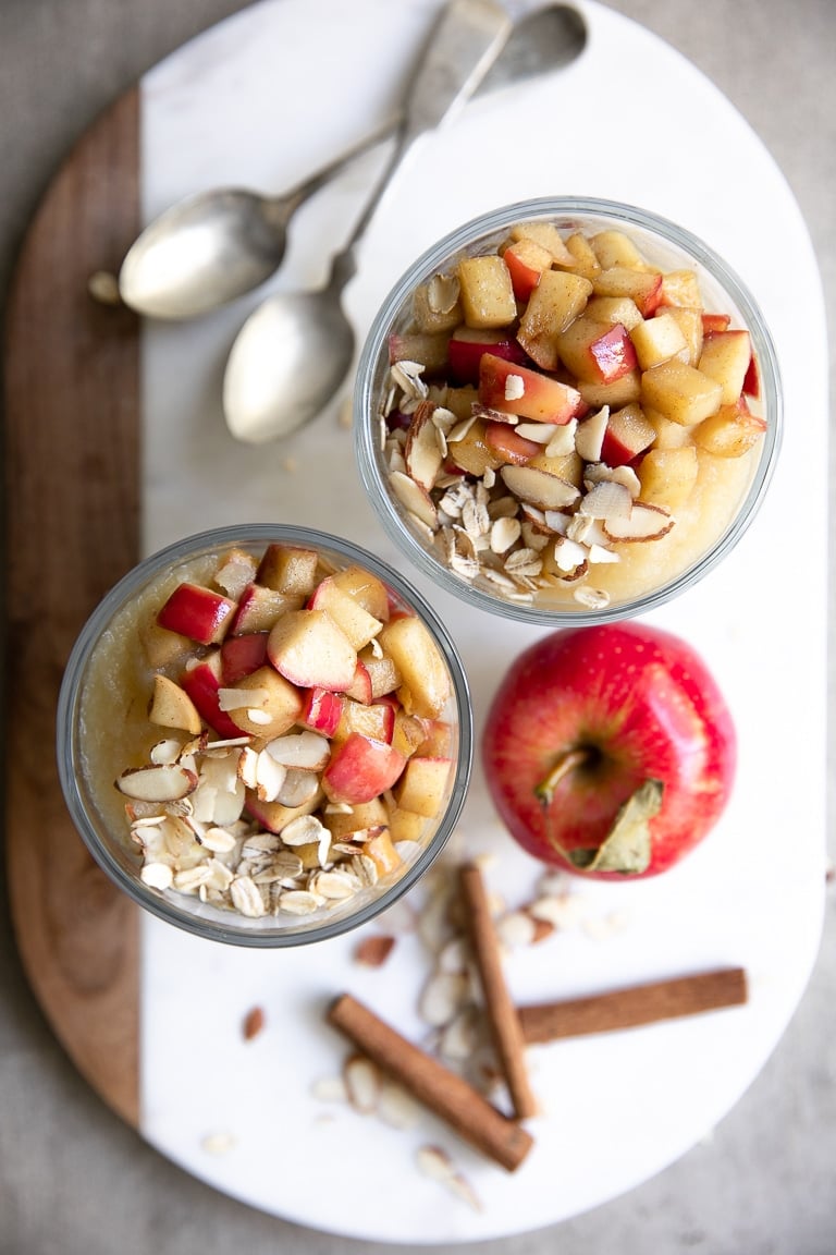 Overhead view of two glass jars filled with apple cinnamon overnight oats.