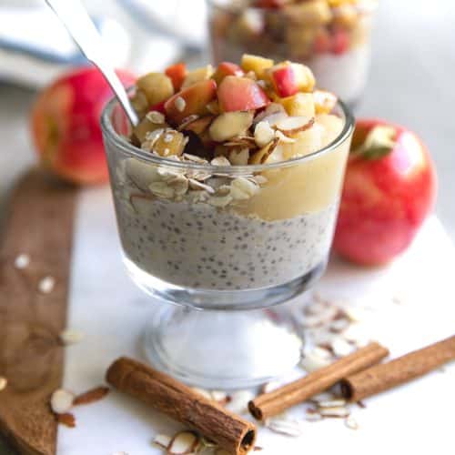 A close up of a glass of overnight oats with fried apples