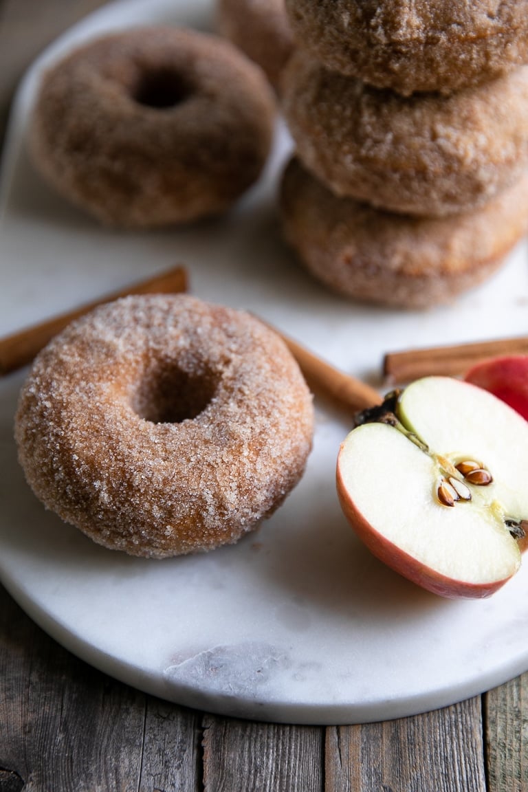 Close up image of an apple donut with crunchy cinnamon sugar outside