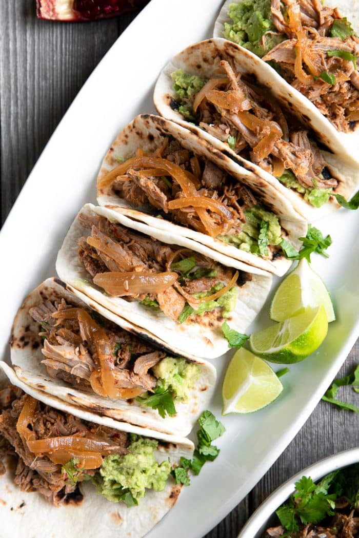 A plate of food with harissa lamb tacos