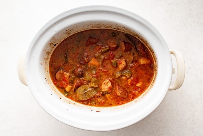 Slow-cooked jambalaya broth with sausage, chicken, and vegetables.