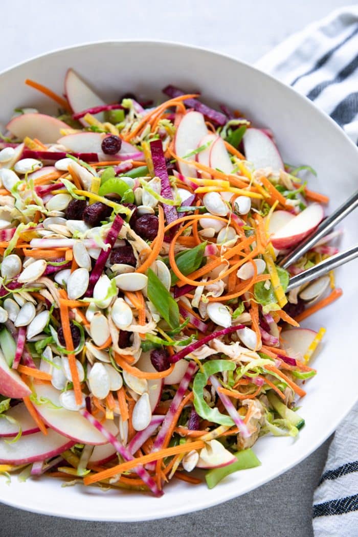 Shredded Brussels sprouts tossed with shredded beets, carrots, pumpkin seeds, apples, cranberries, and a light orange vinaigrette.
