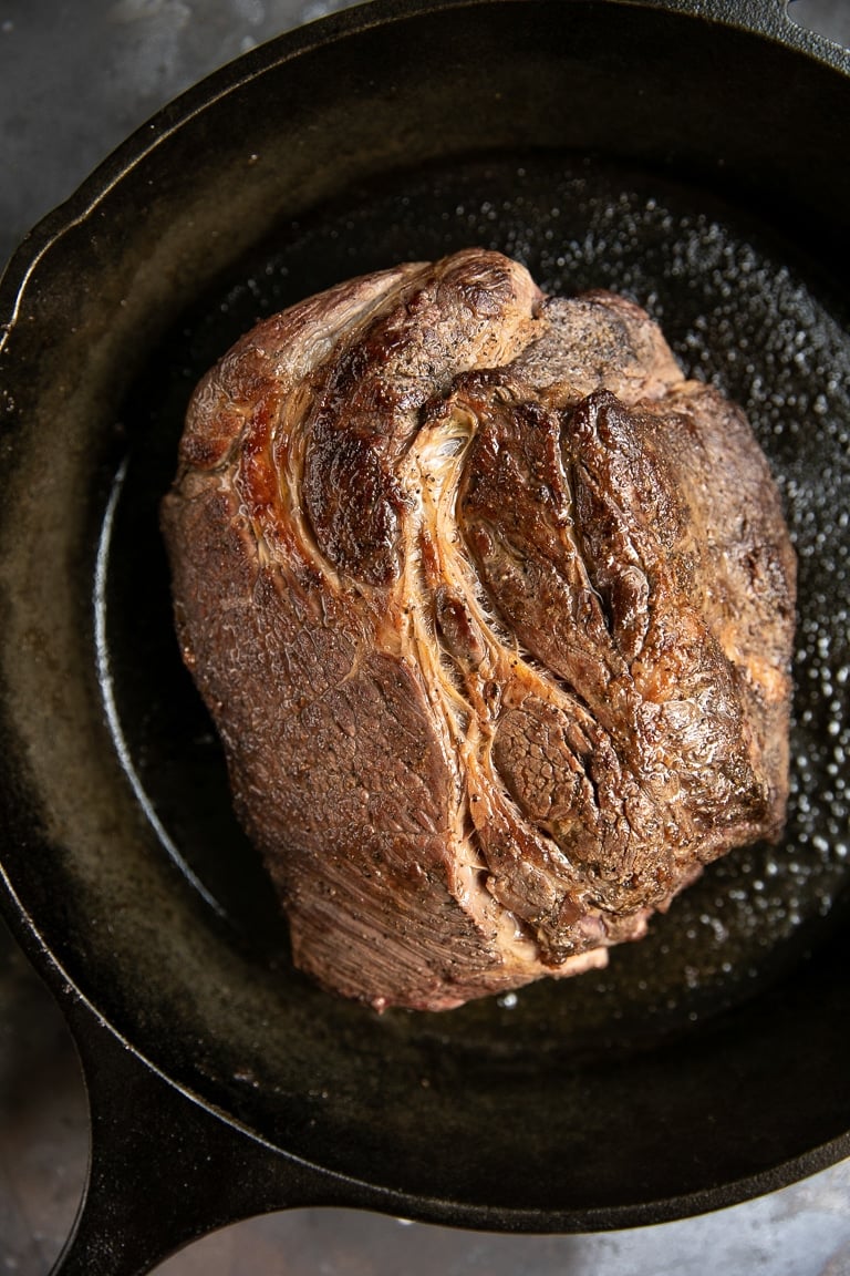 Browned roast in a cast iron skillet.