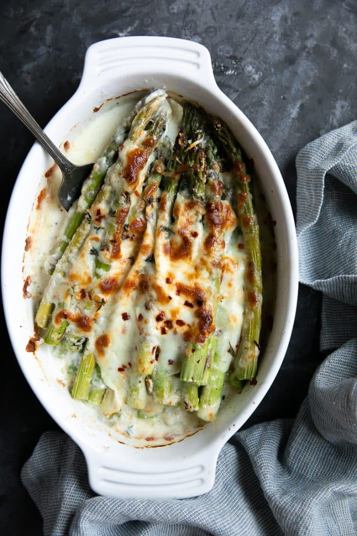 Baked asparagus covered in melted cheese and rich cream.