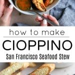 Bowl of cioppino seafood stew filled with crab legs, shrimp, mussels, scallops, and fish, served with a slice of crusty bread and a spoon.