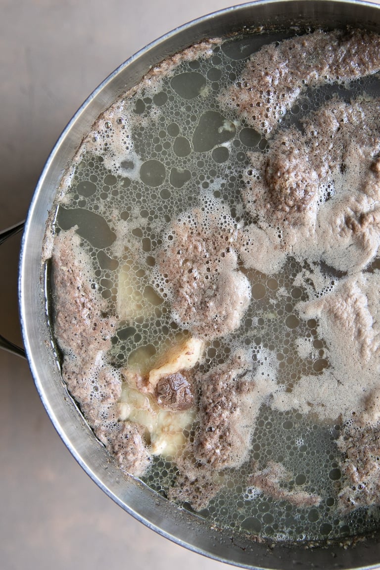 Pot filled with beef bones that were blanched for 15 minutes.