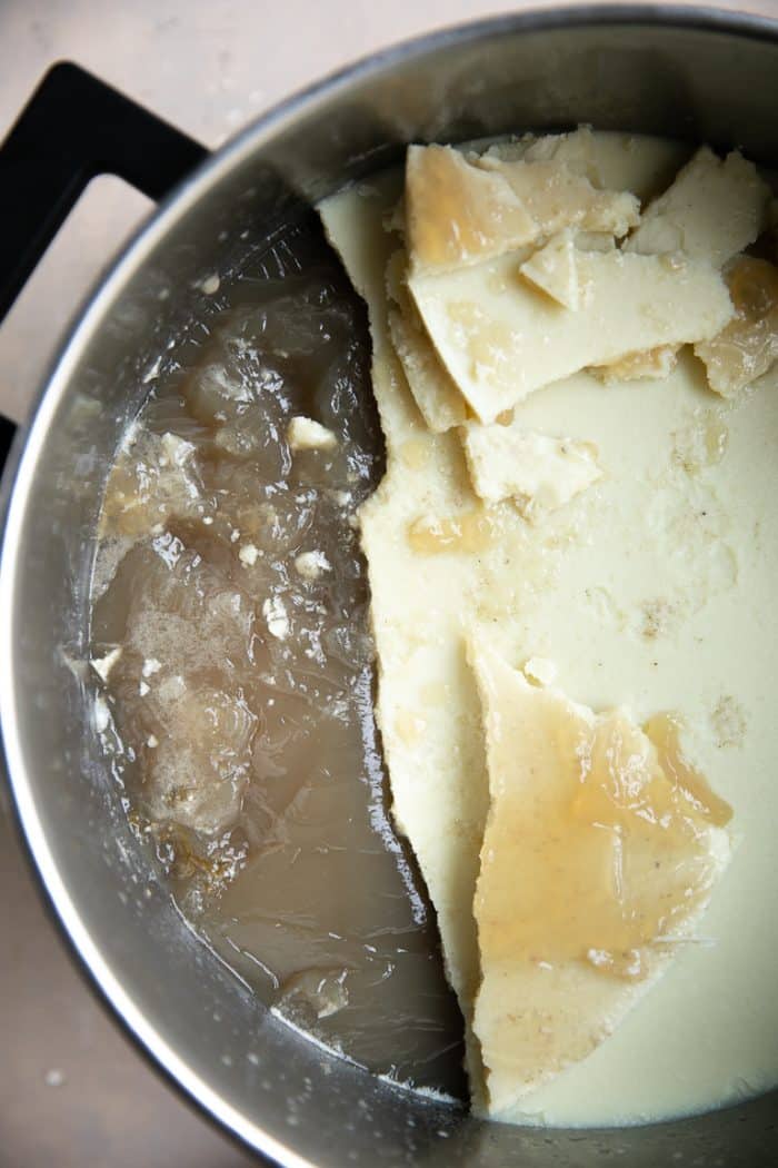 Cooled bone broth with the bottom gelatinous later and top fat later.