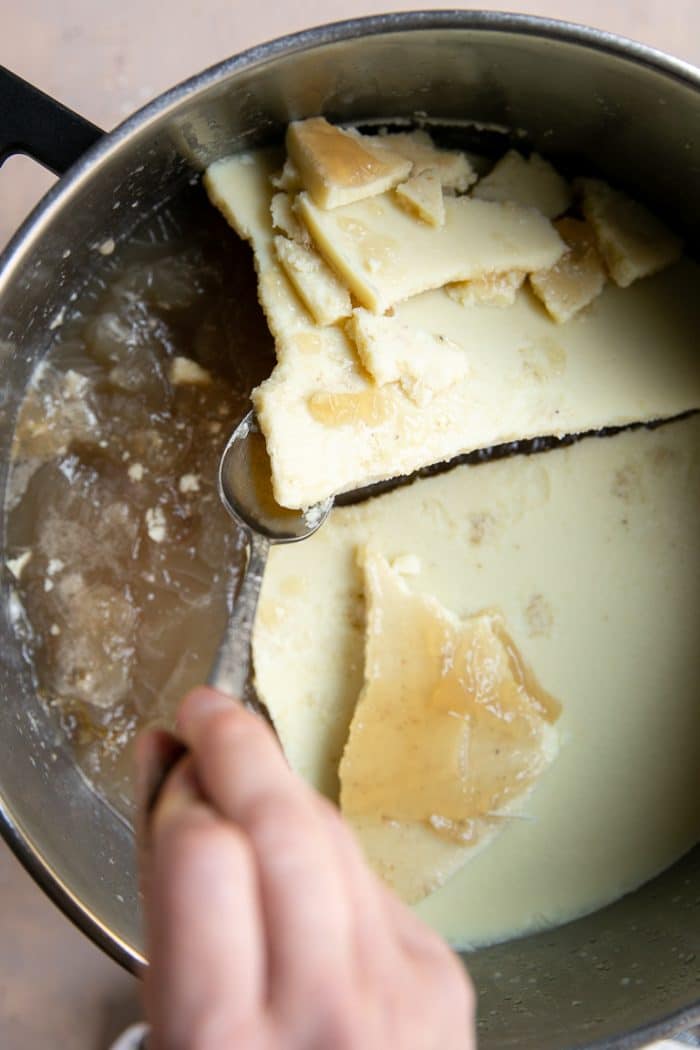 Separating the fat layer from refrigerated homemade bone broth.